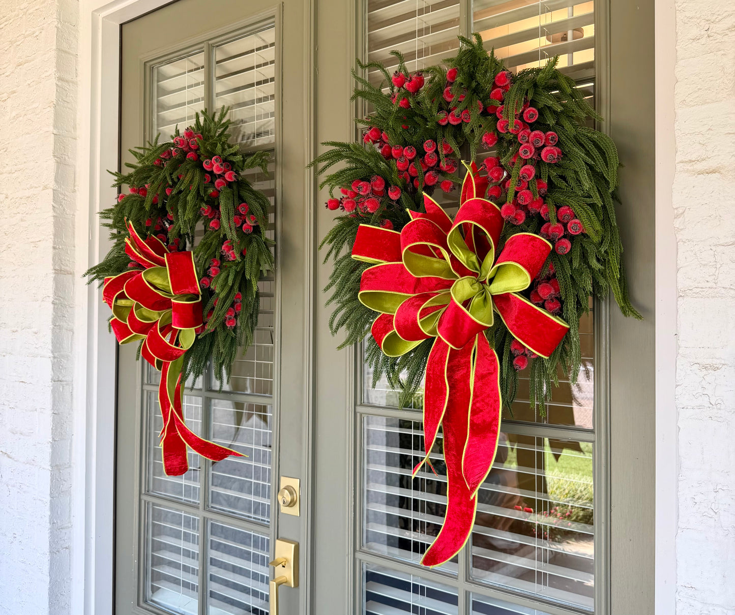 JME faux pine wreath with red berries and a JME red velvet bow with chartreuse accents. About 26 inches in diameter. Some fluffing may be required upon receiving. 