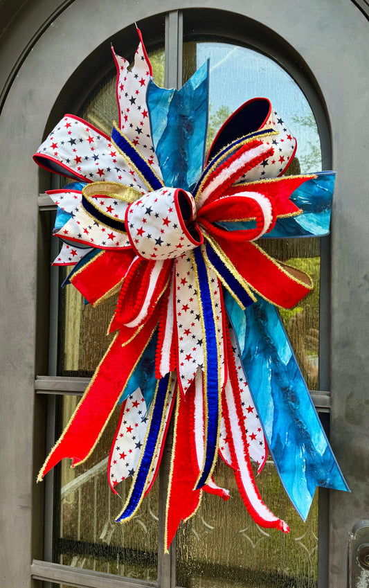 JME lux Patriotic bow with STAR ribbon. Hand-tied by JME. Approximately 22 inches wide and 32 inches long.
