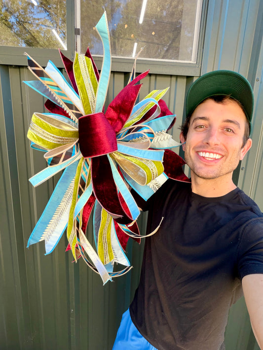 The Singing Bow. hand tied JME bow. Five different ribbons using about 25 yards of ribbon. Approximately 22“ x 30“ long. Some fluffing may be required upon receiving. 