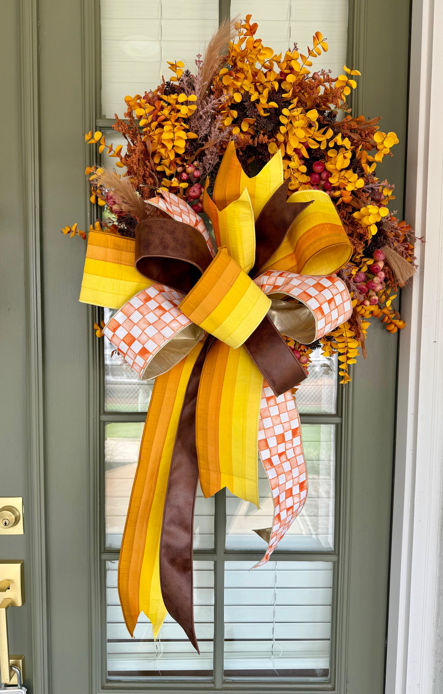 Orange checked ribbon, Faux Mixed fall foliage wreath with hang tied JME bow. About 24 inches wide.