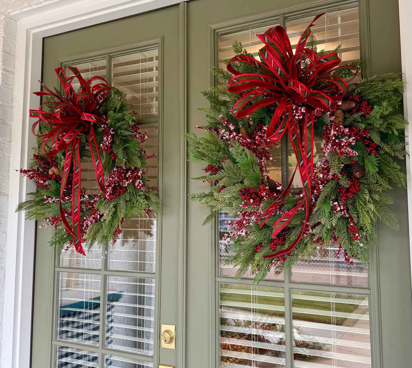 Faux Mixed berry wreath made by JME with a bias plaid hand tie JME bow. About 24 inches wide. 