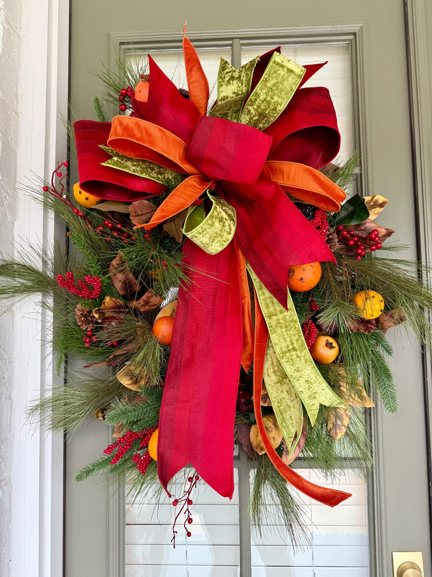 Faux Cove and fruit wreath with hand tied JME bow. About 24 inches wide.