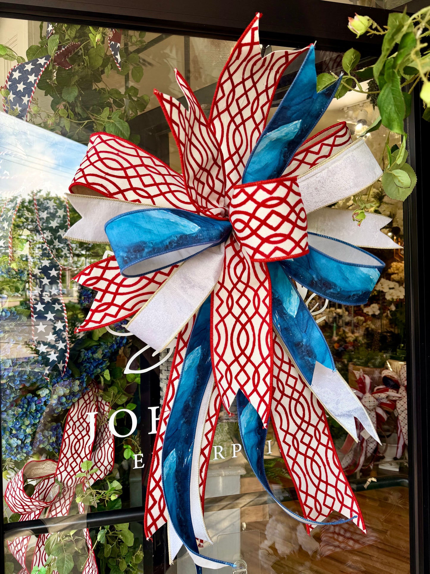 Patriotic JME hand tied bow. Some fluffing might be required upon receiving. Approximately 23 inches wide by 30 inches long.