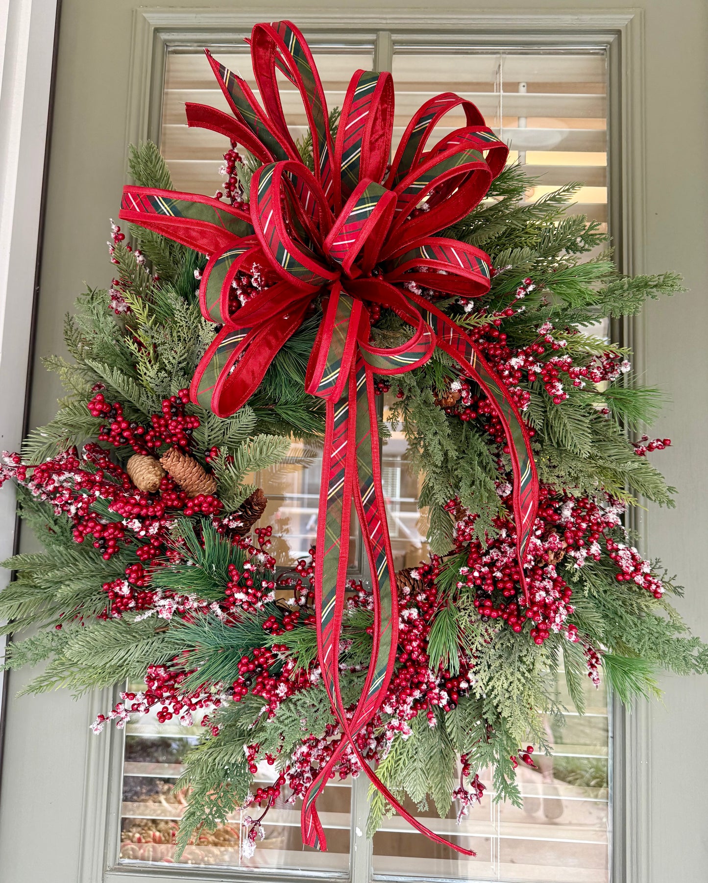 Faux Mixed berry wreath made by JME with a bias plaid hand tie JME bow. About 24 inches wide. 