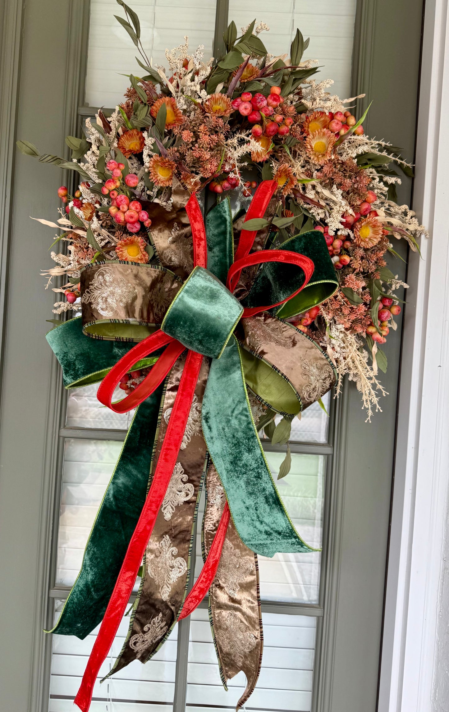 Green brown and orange faux fall wreath with hand tied JME bow. About 24 inches wide