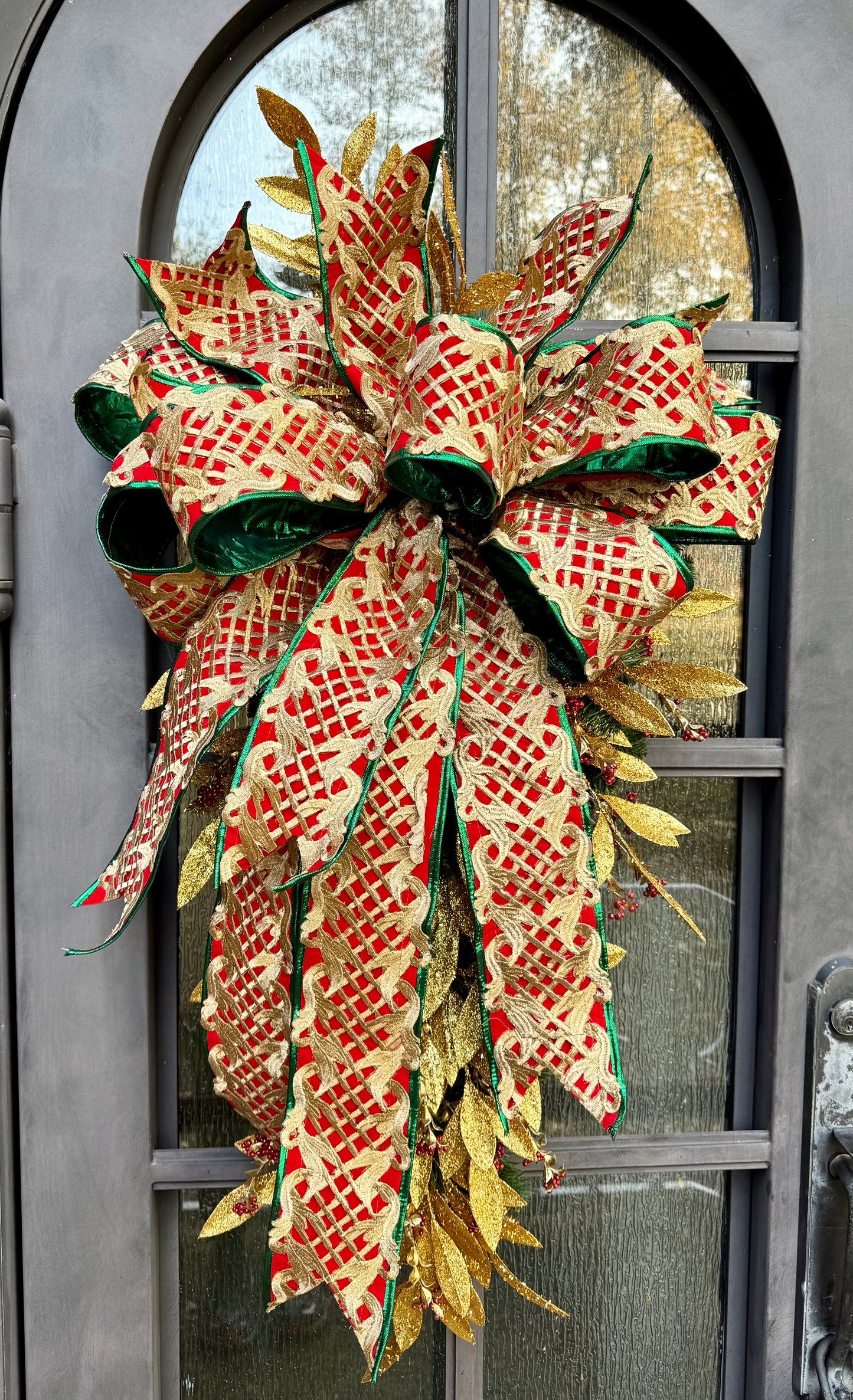 JME regal Christmas swag. Red and gold with a touch a green and tied with a JME hand tied bow. Has jingle bells. About 4 feet long by 2 foot wide.