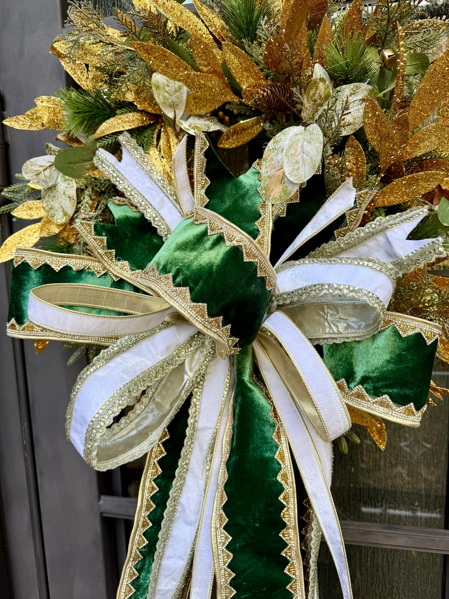 Greens and gold wreath. Handmade wreath by JME paired WITH A JME Handtied bow of velvets and jewels. About 24 inches wide