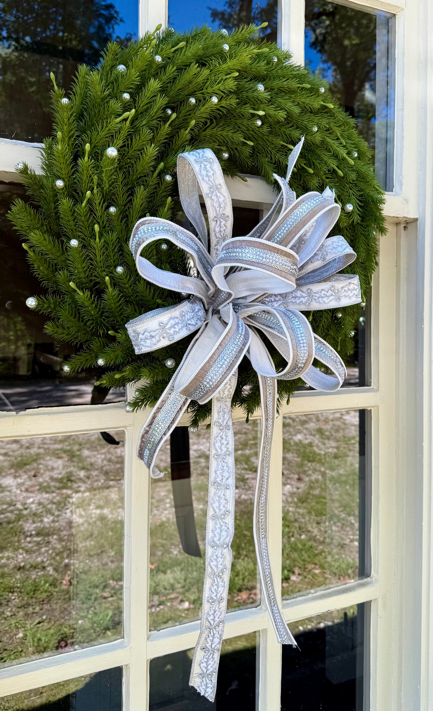 Pearl wreath with a JME hand tied bow. About 24 inches wide.