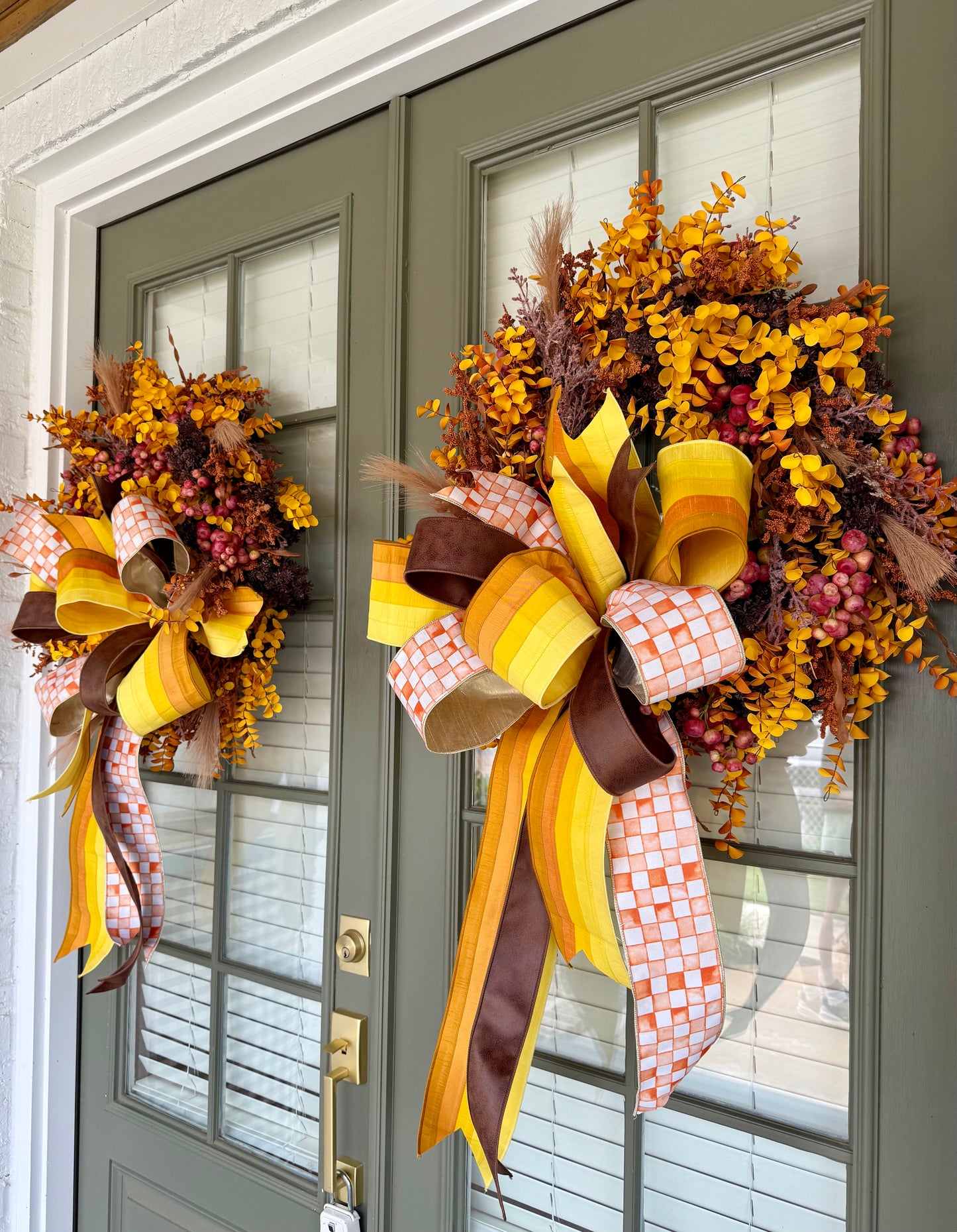 Orange checked ribbon, Faux Mixed fall foliage wreath with hang tied JME bow. About 24 inches wide.