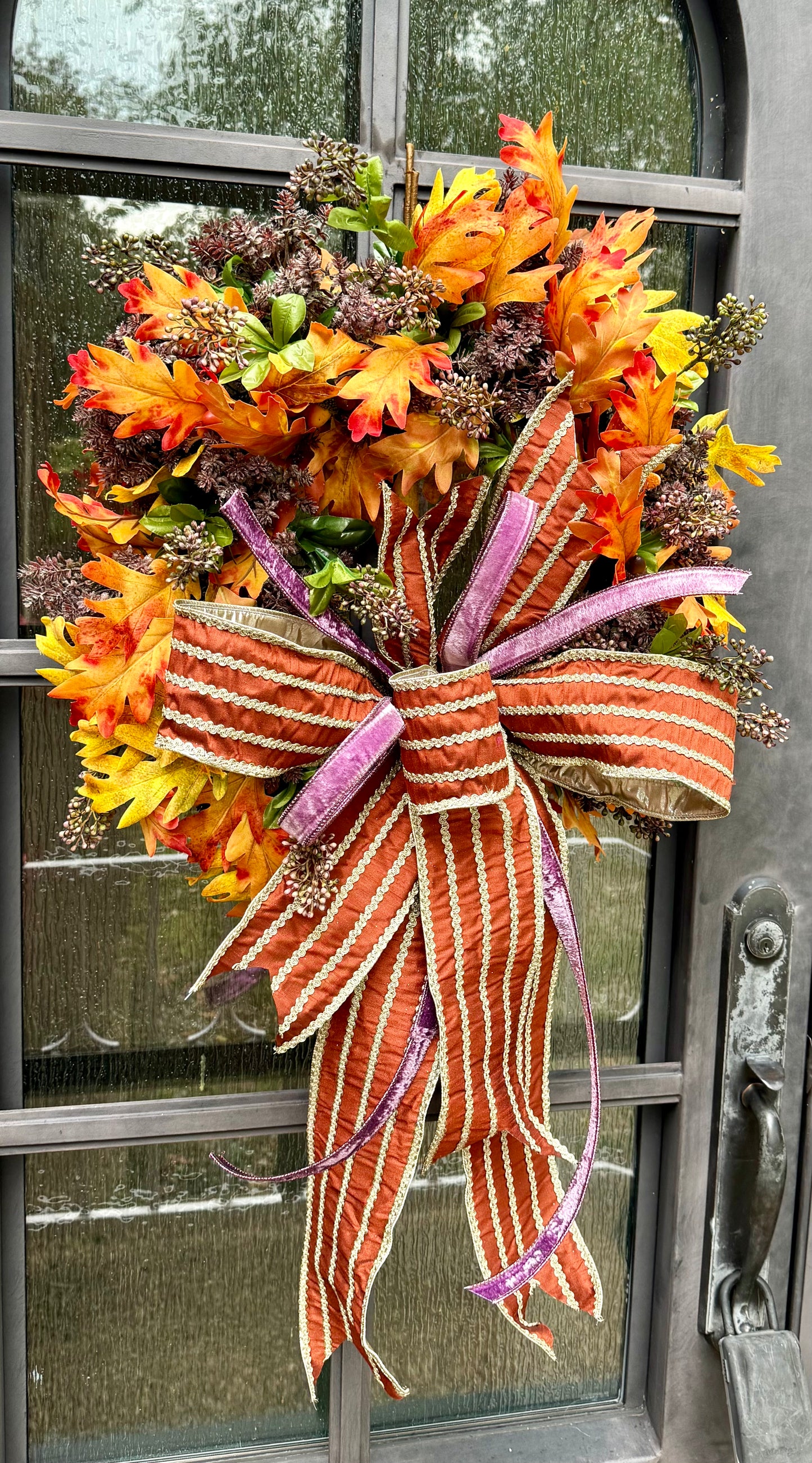 A touch of purple for fall! Handmade fall wreath with sedums in it. And a JME hand tied bow.