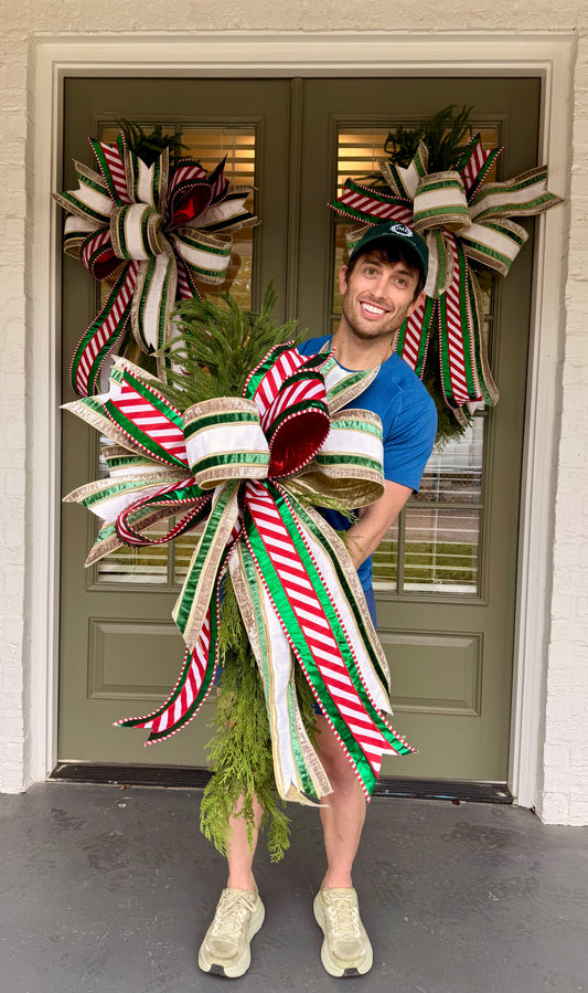 Cedar swag with a JME hand-tied bow using 6in velvet ribbon paired with a pattered ribbon. About 42 inches long