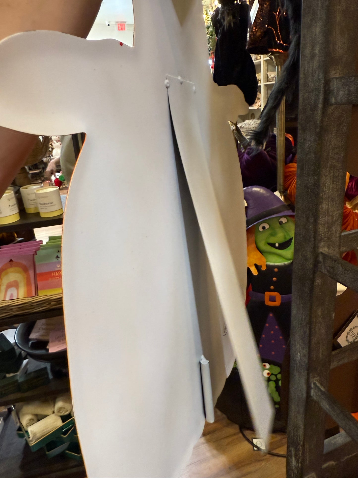 Metal jack-o’-lantern with witch hat stake. Orange. 24 inches. Has an easel that can be propped up on the back and it has a hook that could be hung on the door or wall.