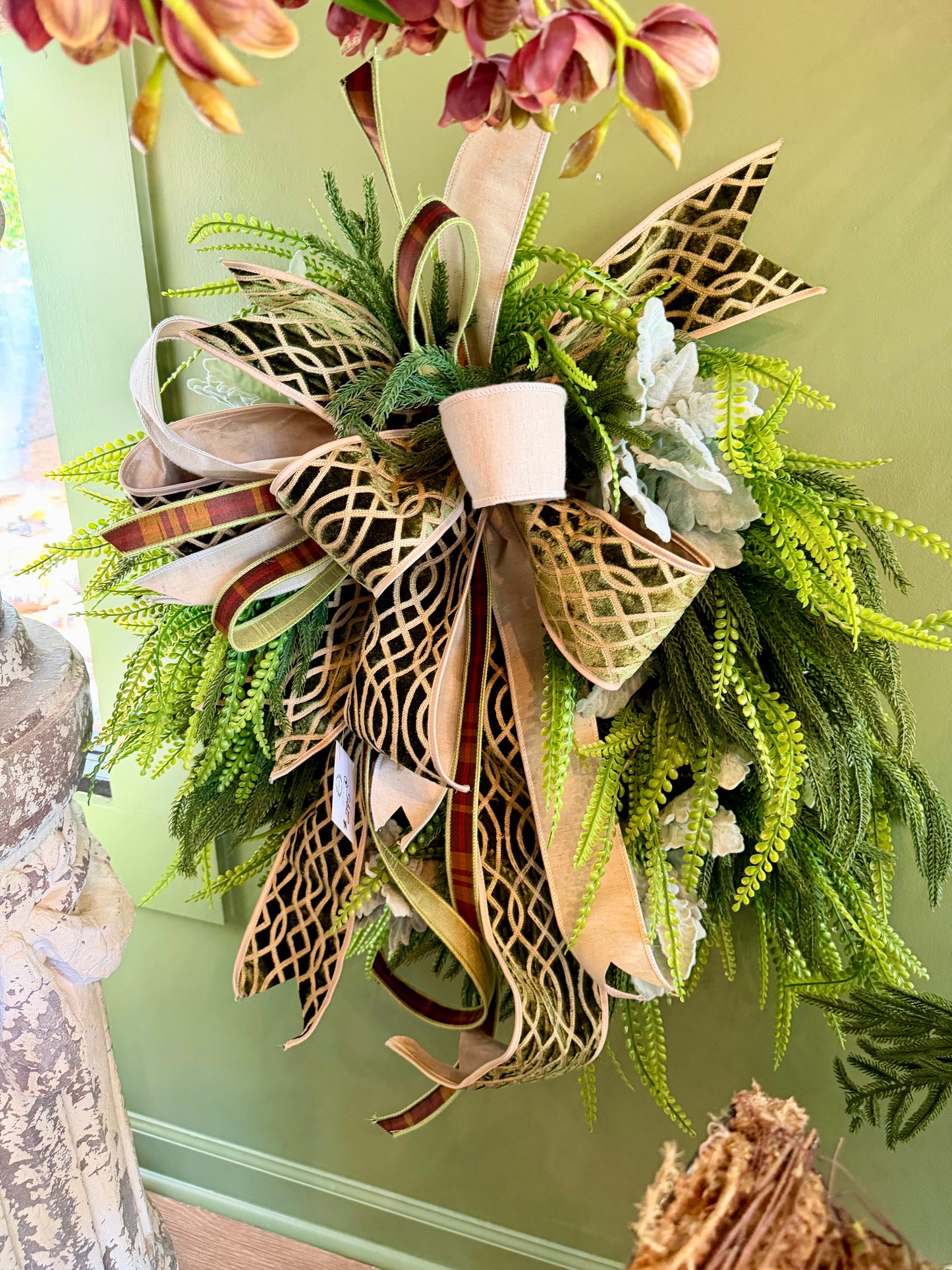 Handmade mixed greenery wreath of faux fern, Norfolk pine, and dusty miller, with a JME hand tied bow. About 30inches in diameter. Some fluffing may be required upon receiving.