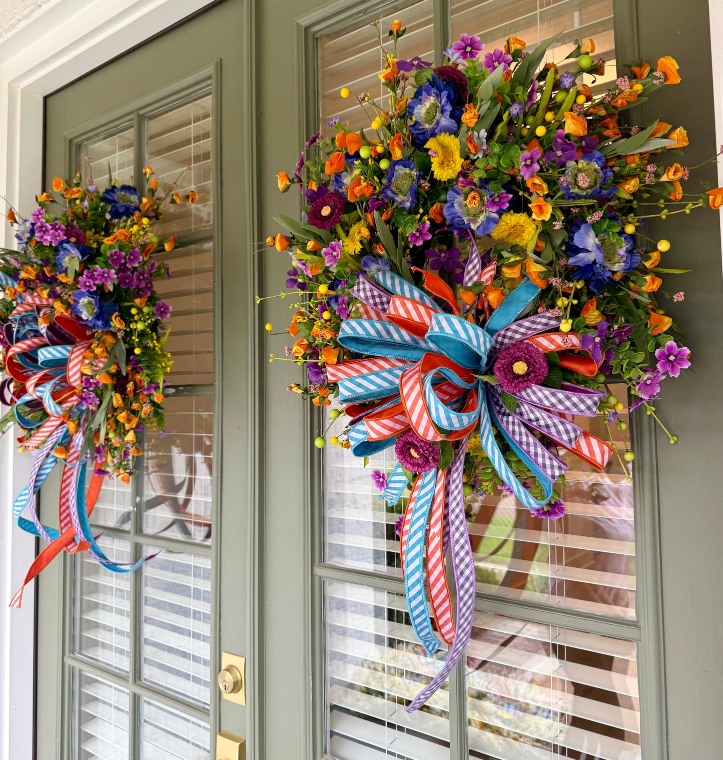 Summertime JME handmade wreath. Made with faux florals and paired with a JME hand tied bow. About 24 inches in diameter.