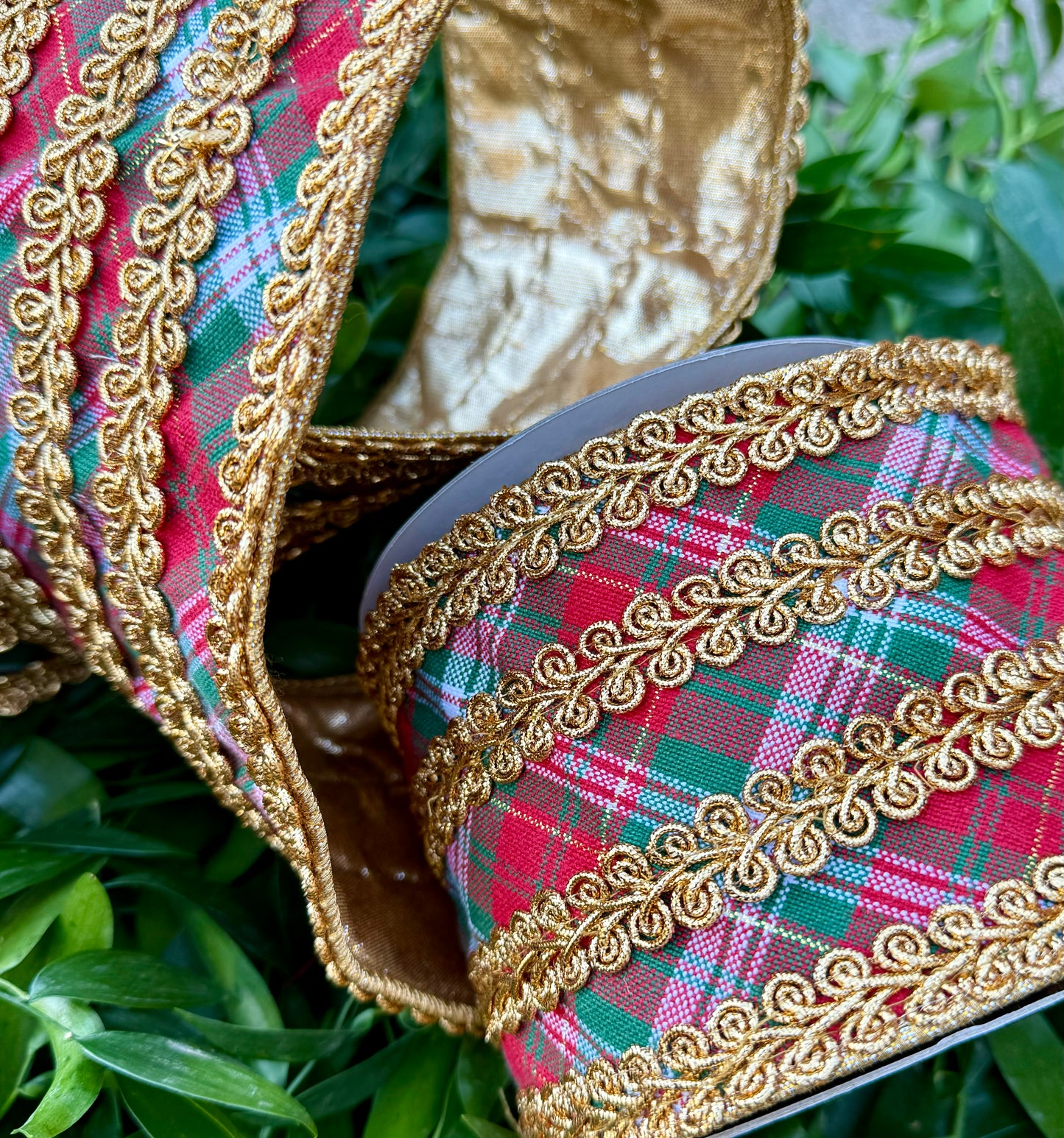 JME heavy wire ribbon. Traditional red green white plaid with gold embroidering belts down the center and on the edge. Backed with the gold metallic. 4“ x 5 yards.