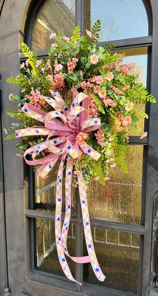 Handmade wreath with a JME hand tied bow. Made of fern, pink berries and dainty blush blooms. About 24 inches in diameter. 
