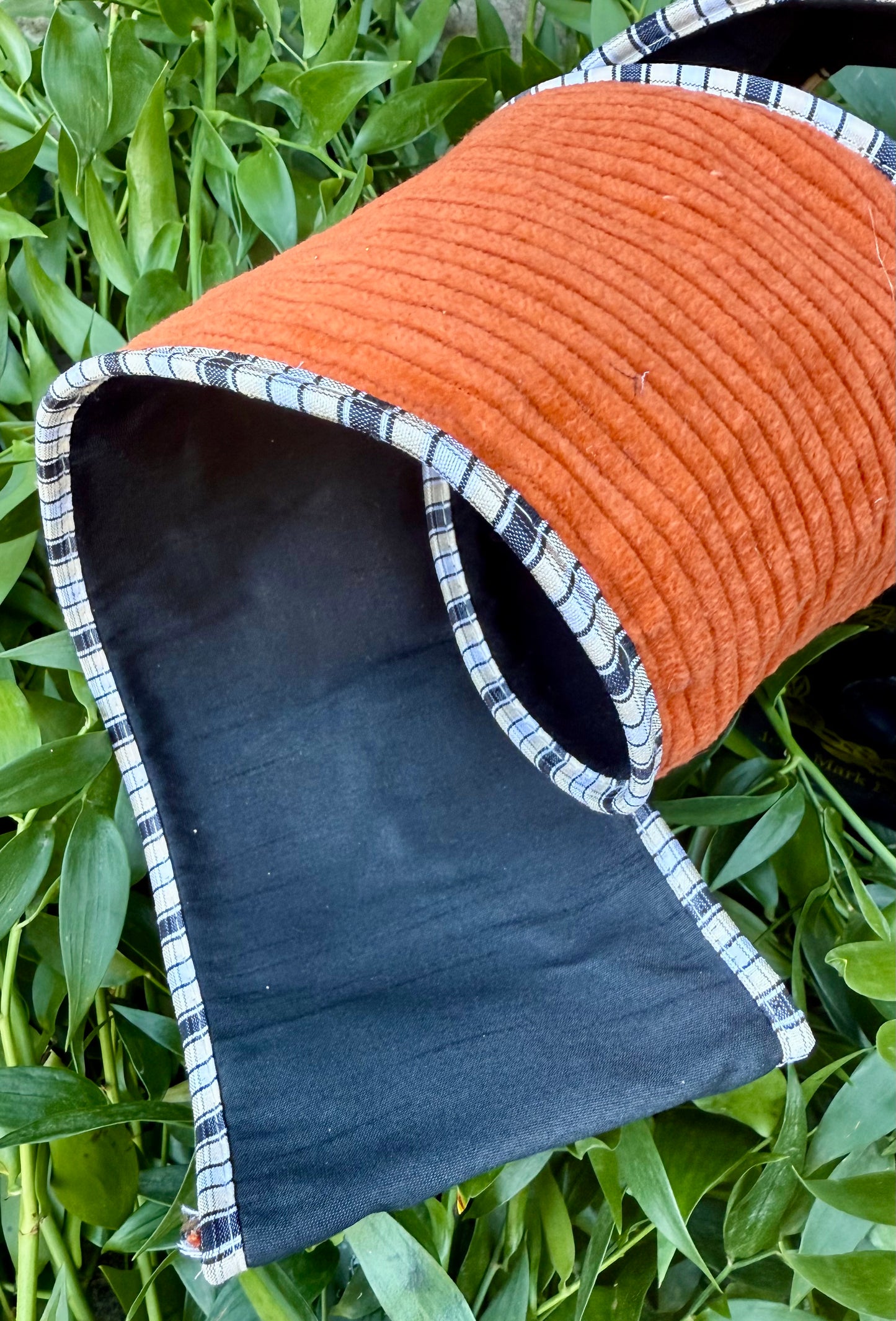 JME heavy wired ribbon. Burnt Orange corduroy backed with black taffeta and piped with black and white checked. 4” x 5 yards.