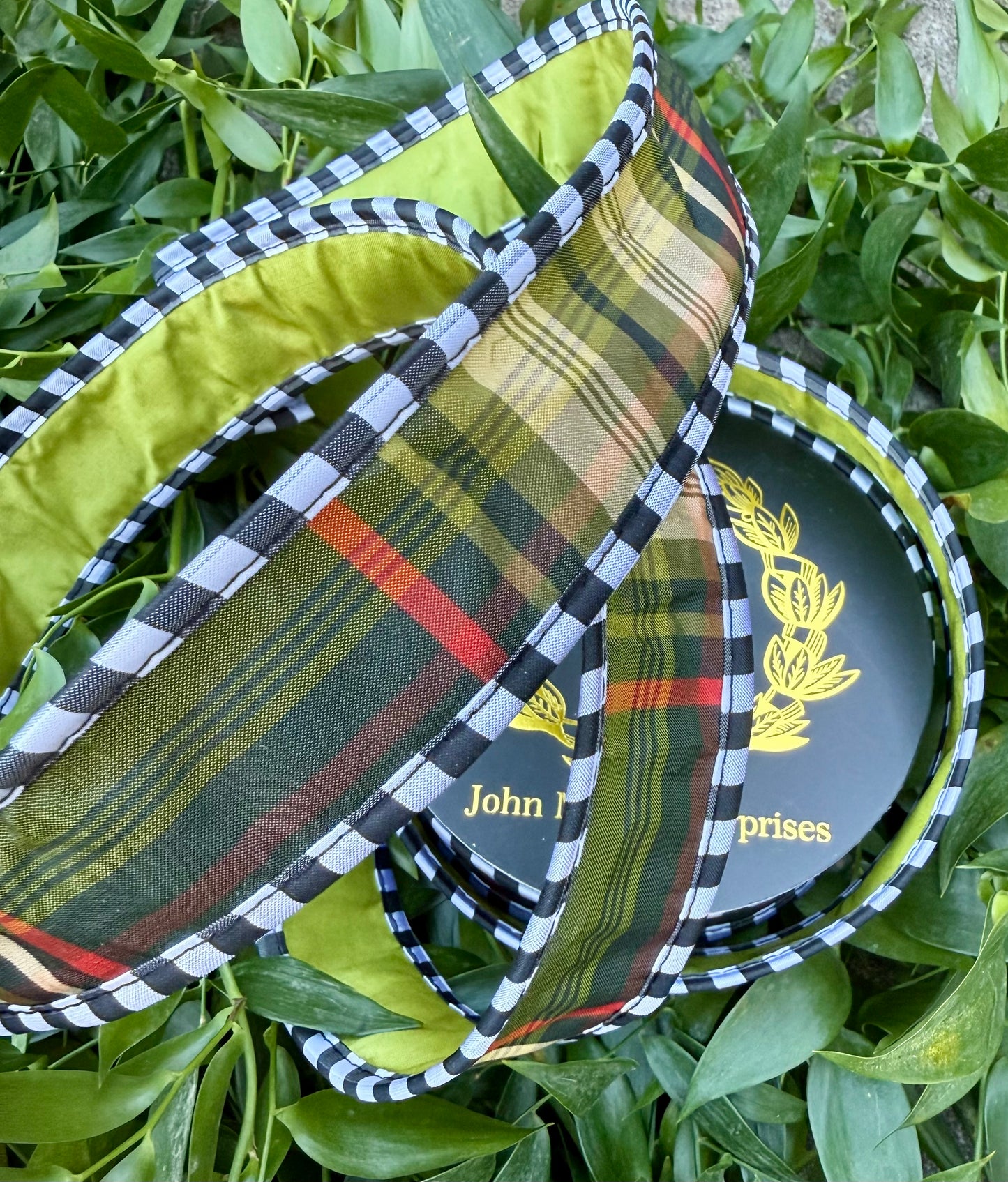 JME heavy wire ribbon. Black and green plaid with black and white, checked piping and back with green taffeta . 1.5“ x 10 yards.