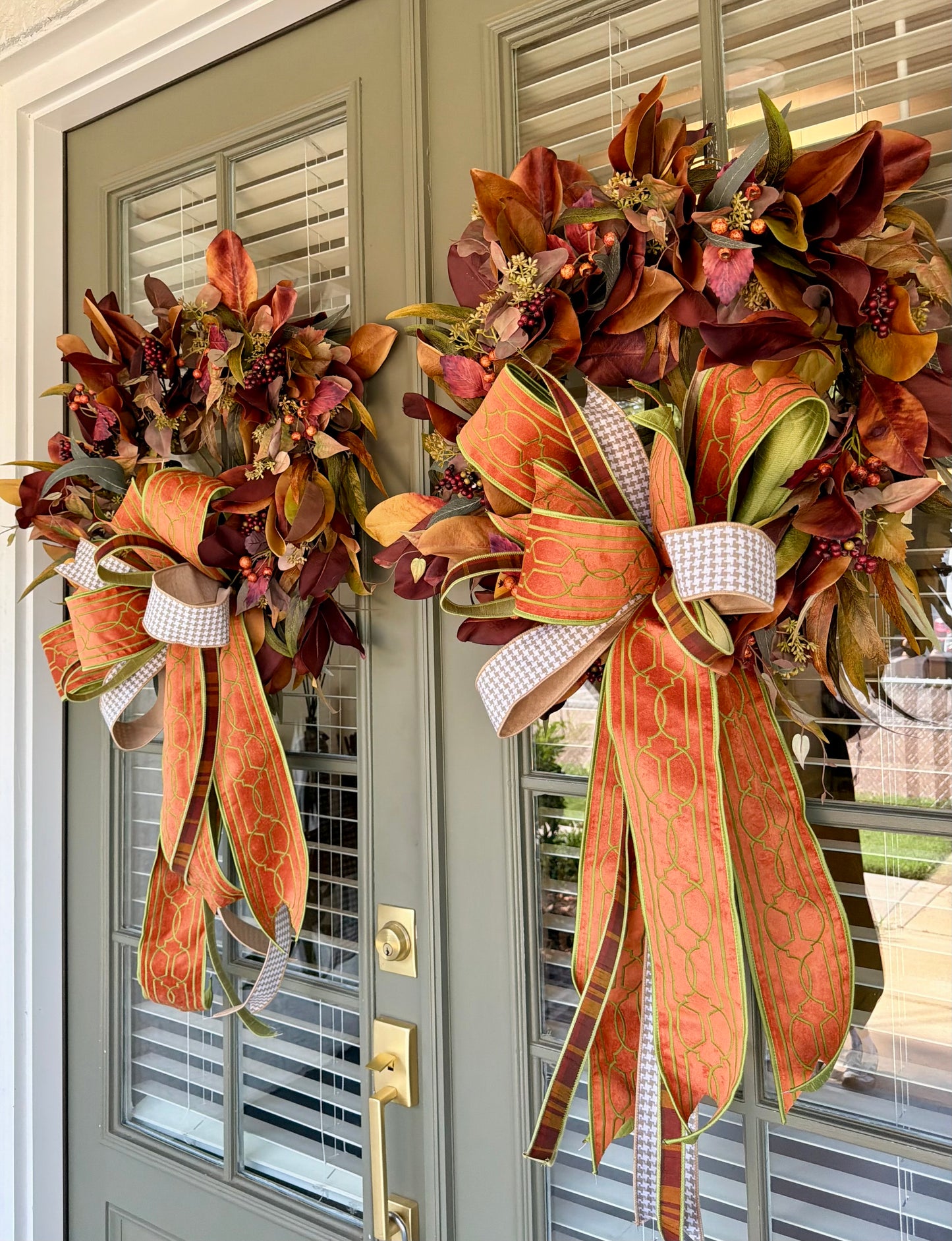 JME fall faux MAGNOLIA WREATH paired with other fall botanicals. About 26inches in diameter. Paired with a JME hand tied bow of orange and browns. Some fluffing may be required upon receiving.