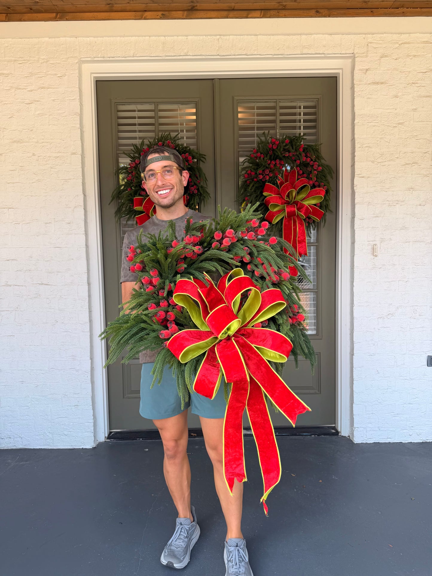 JME faux pine wreath with red berries and a  JME red velvet bow with chartreuse accents. About 26 inches in diameter. Some fluffing may be required upon receiving. ￼