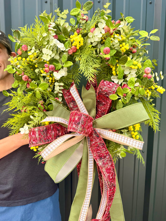 JME HANDMADE WREATH. Lush mimosa Apple wreath. Paired with a JME hand tied bow. About 26 inches wide.