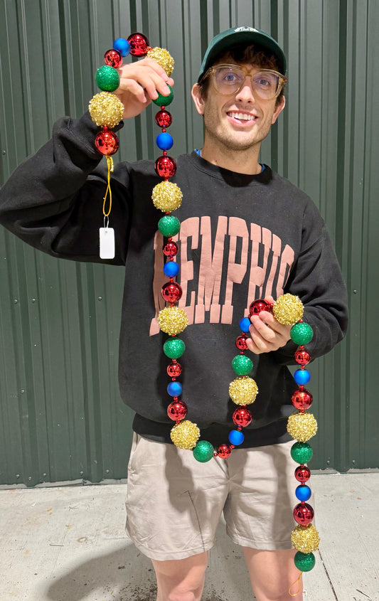 Gold, red emerald and royal ball garland. A collection of sequin and glittered Balls strong together. 72 inches long. Shatter proof