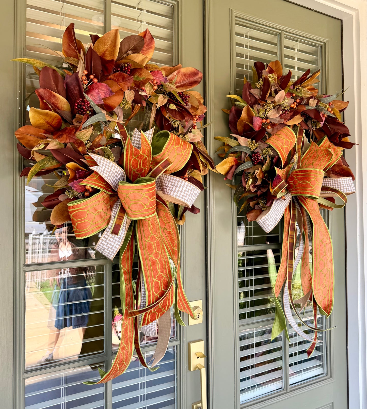 JME fall faux MAGNOLIA WREATH paired with other fall botanicals. About 26inches in diameter. Paired with a JME hand tied bow of orange and browns. Some fluffing may be required upon receiving.