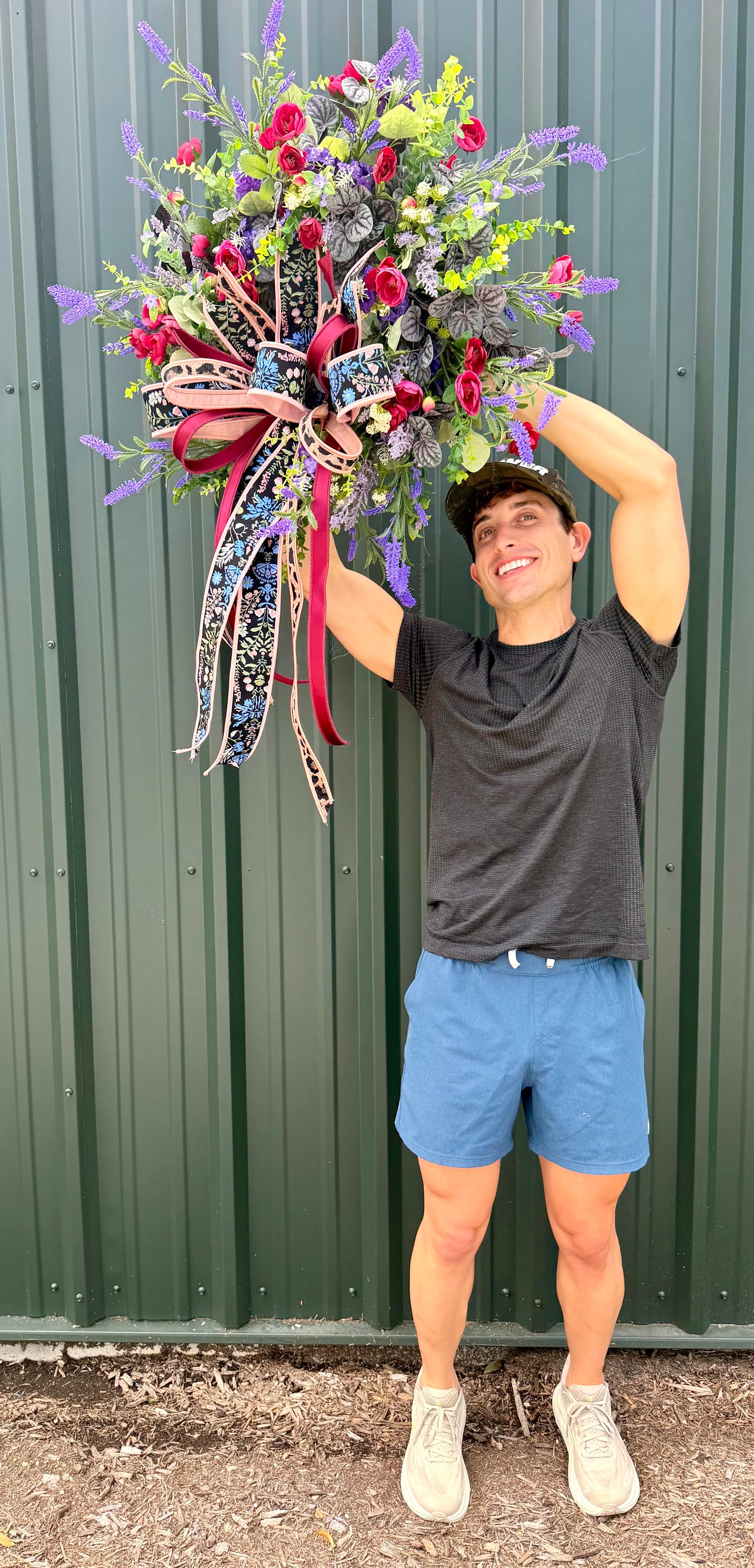 JME HANDMADE WREATH. Lush deep colors of purples and burgundies. Paired with a JME hand tied bow. About 26 inches wide.