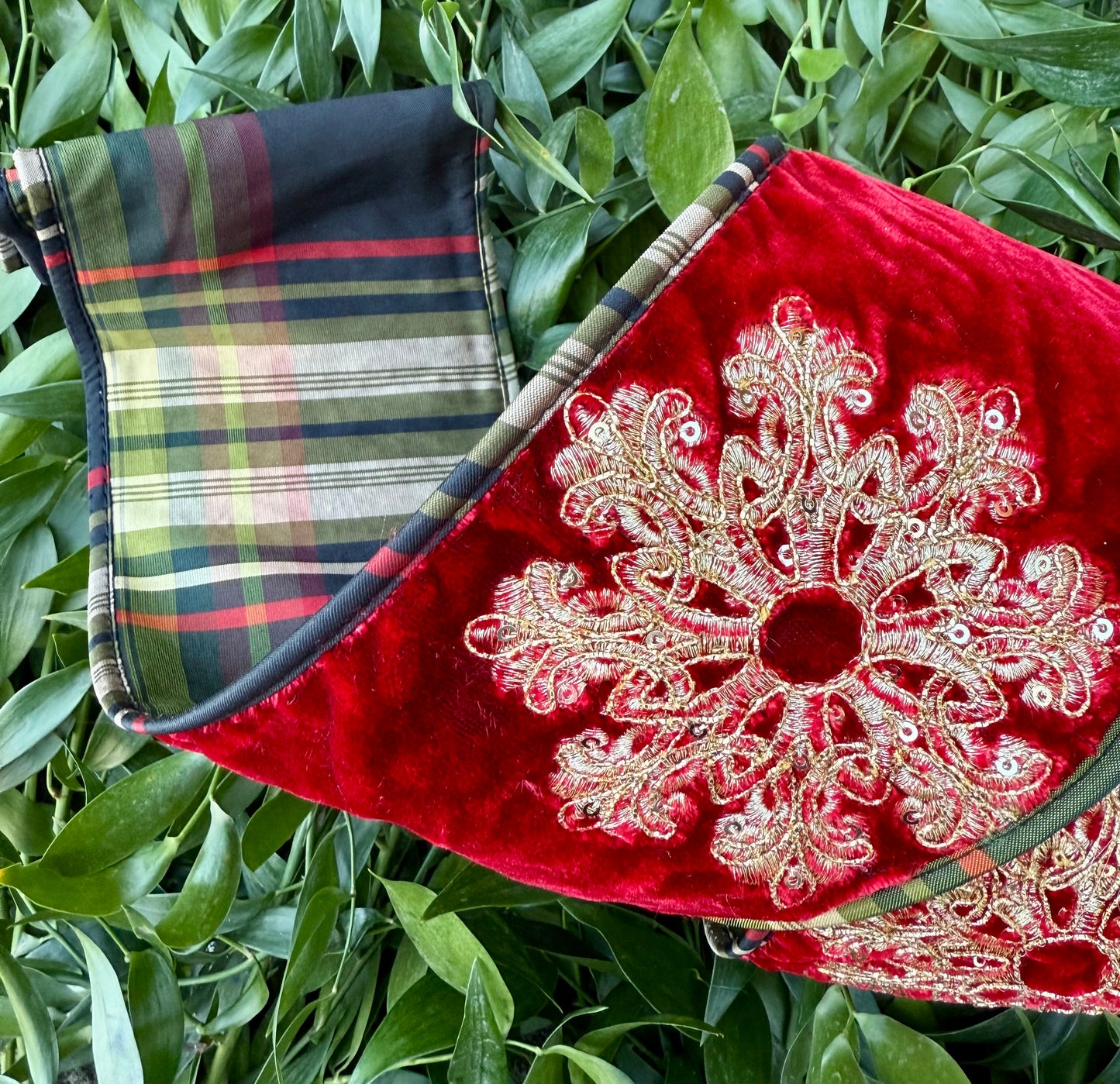 JME heavy wire ribbon. Red velvet with gold embroidered snowflakes backed with black and green plaid and piped down the sides. 4“ x 5 yards.