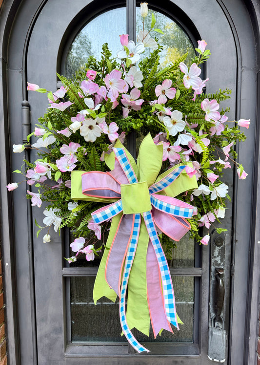 JME hand made wreath. Pink and White Dogwood Florals with Mixed Greenery with a JME hand tied Lime and Pink Bow. About 26 inches in diameter.