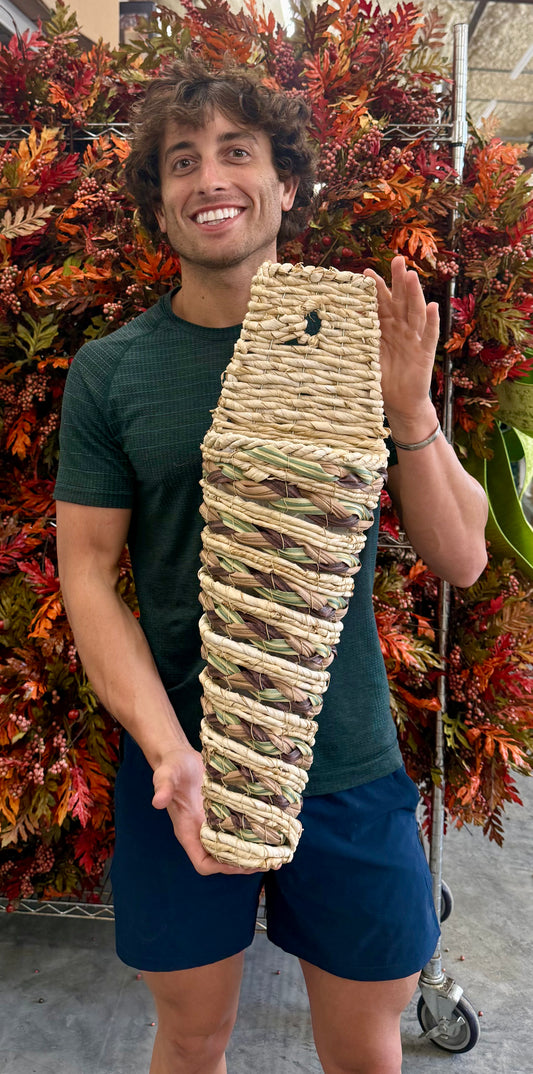 Small cone woven basket with plastic liner. 24 inches long by 8 inches wide.