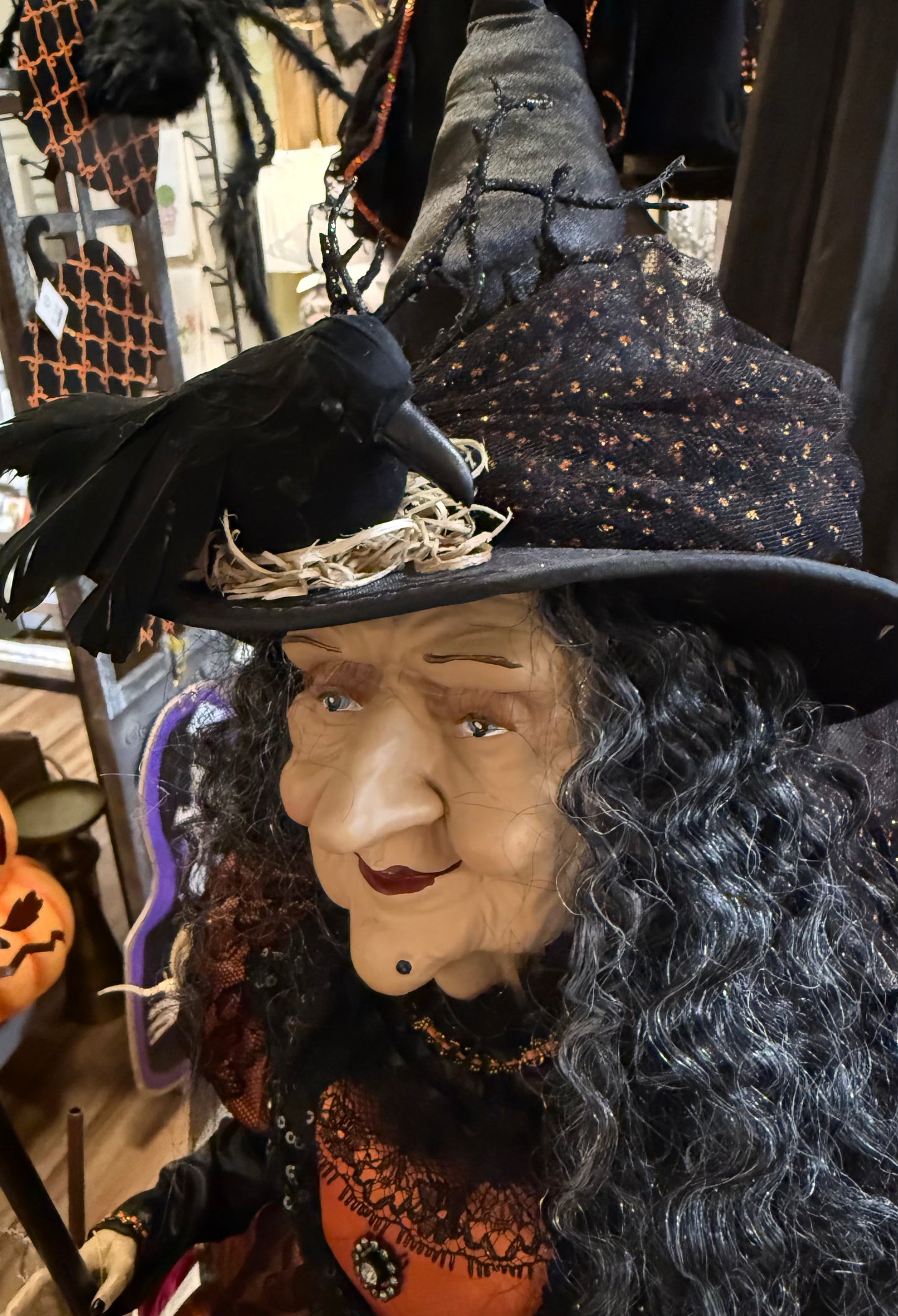 Tall witch figurine, holding a light up jack-o’-lantern. 42 inches tall. Has a Crow on her hat!