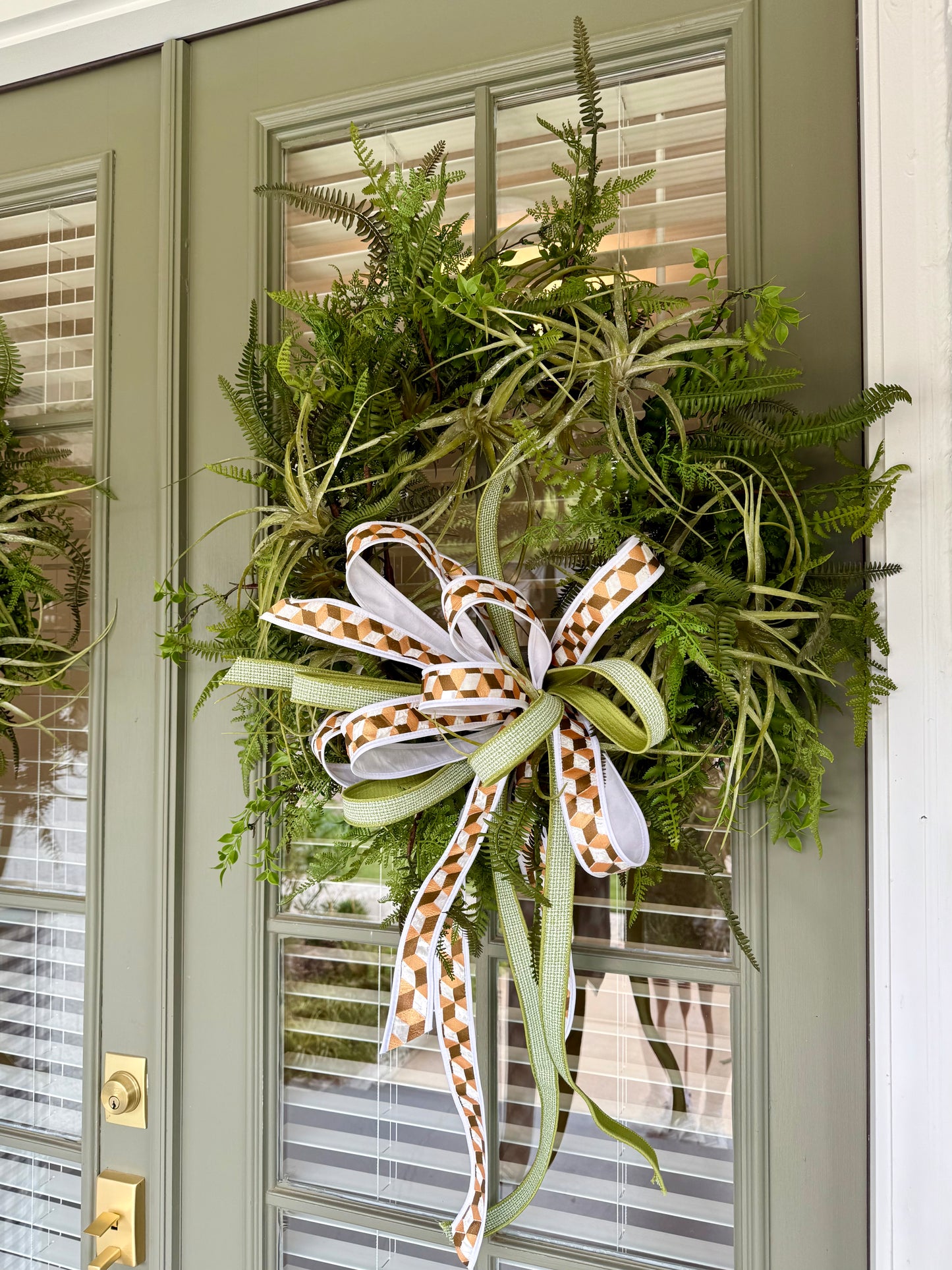JME faux Succulent and fern wreath. With a JME ribbon bow! Around 24 inches wide.