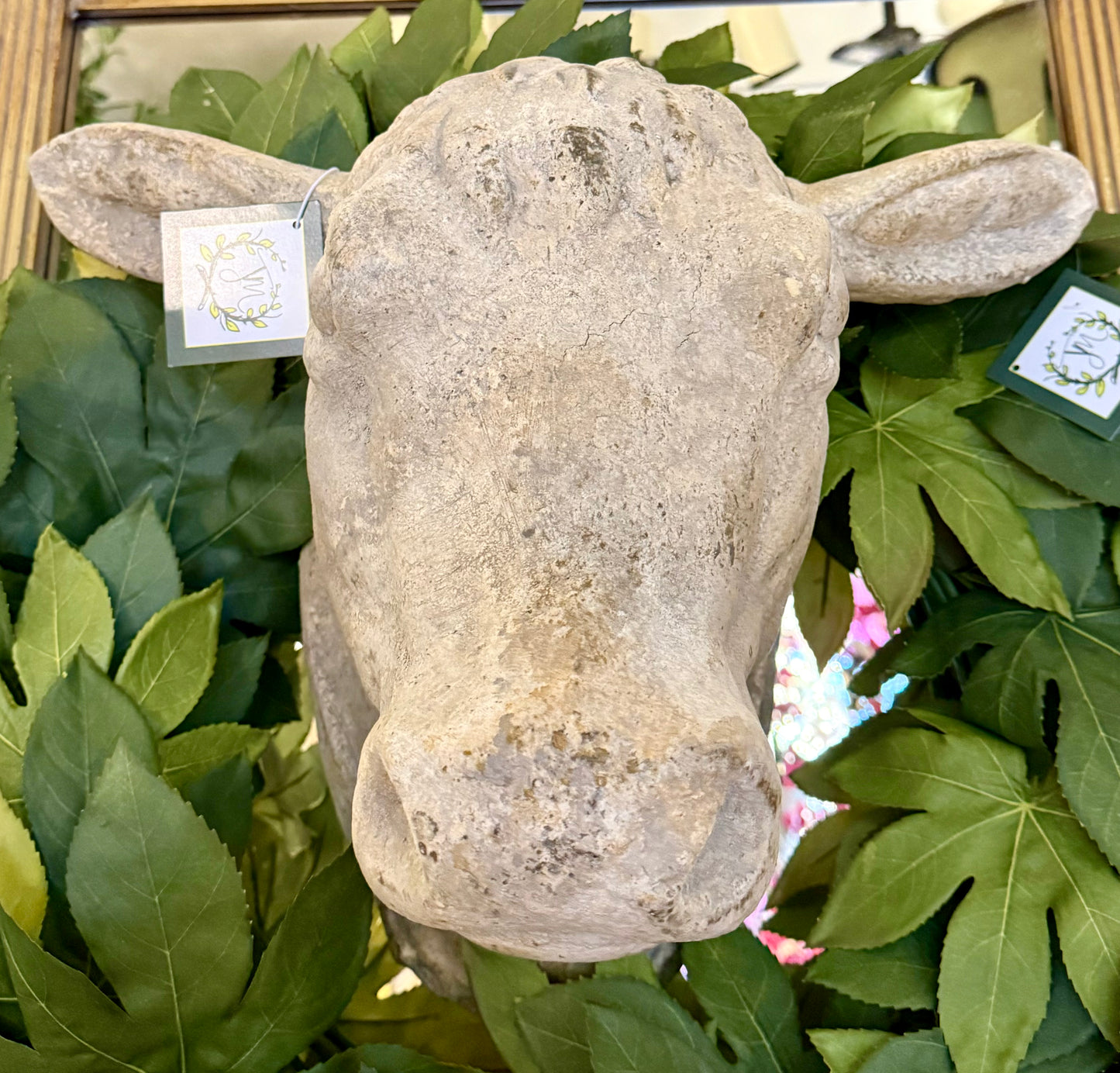 Weathered Stone Cow head. Able to be mounted on the wall. Greenery sold separately.