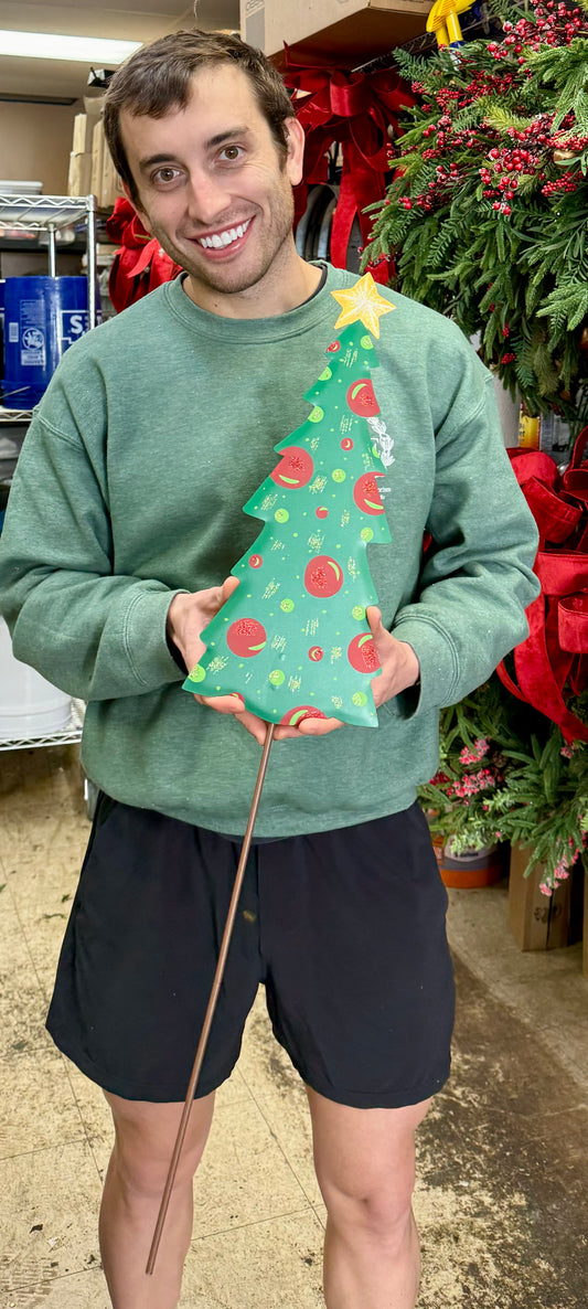 Metal tree with red and green ornaments. Made for indoor outdoor use can be hung on the door or staked in the yard or planter. Stake comes off.