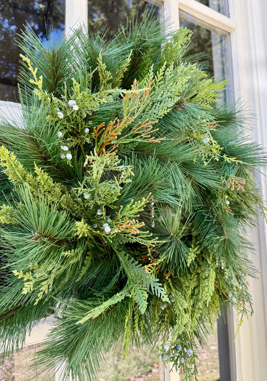 Faux mixed foliage wreath with Juniper and Cedar. 24 inches. Perfect for windows, mirrors, doors and more! Beautiful alone or with a simple bow.