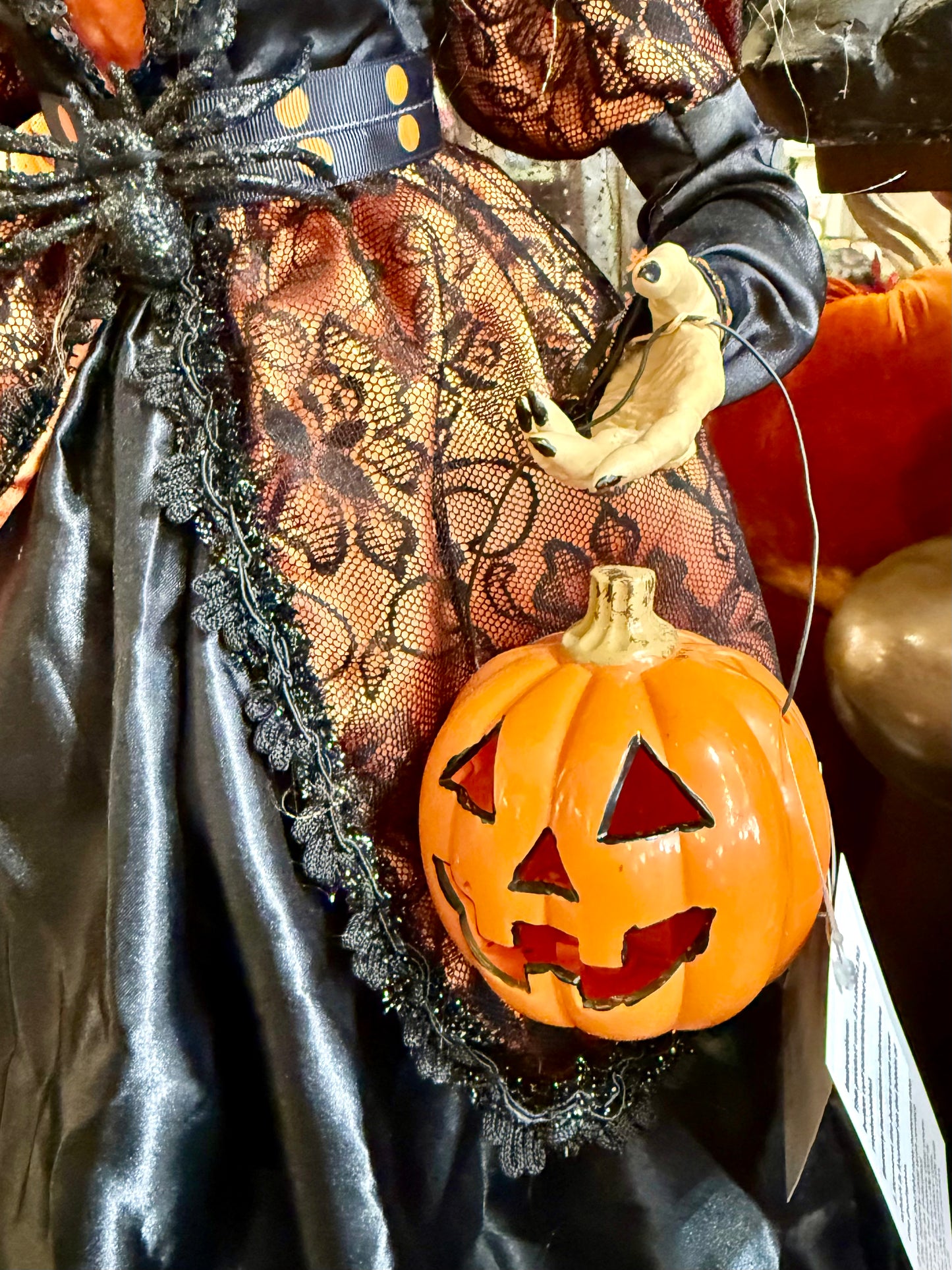 Tall witch figurine, holding a light up jack-o’-lantern. 42 inches tall. Has a Crow on her hat!