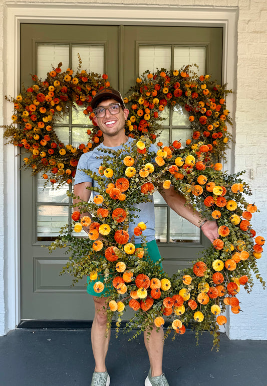 Faux orange velvet pumpkin wreath. 32 inches wide.