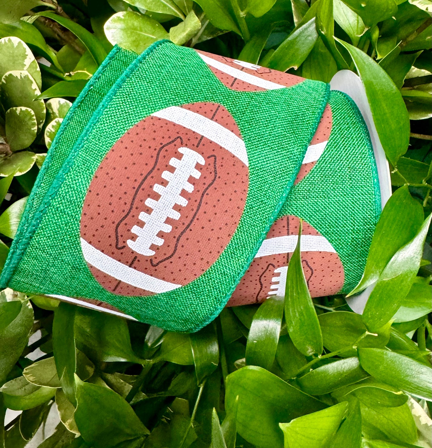 Football on green ribbon wired. 2.5” x 10 yards.