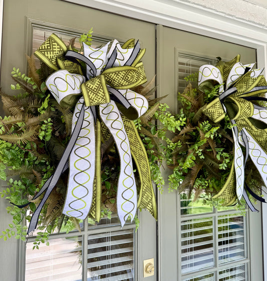JME faux mixed fern wreath with a hand tied JME ribbon bow! About 30 inches wide.