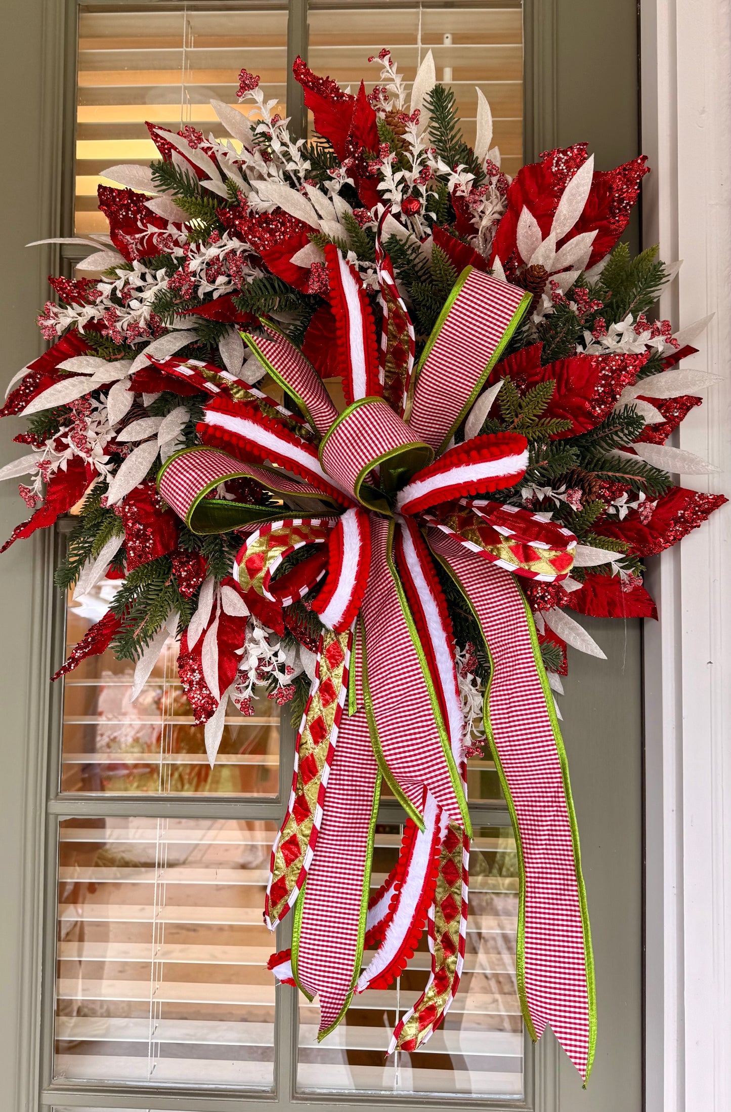 Candy Cane inspired wreath. Handmade by JME paired with a JM hand tied bow. About 24inches wide.