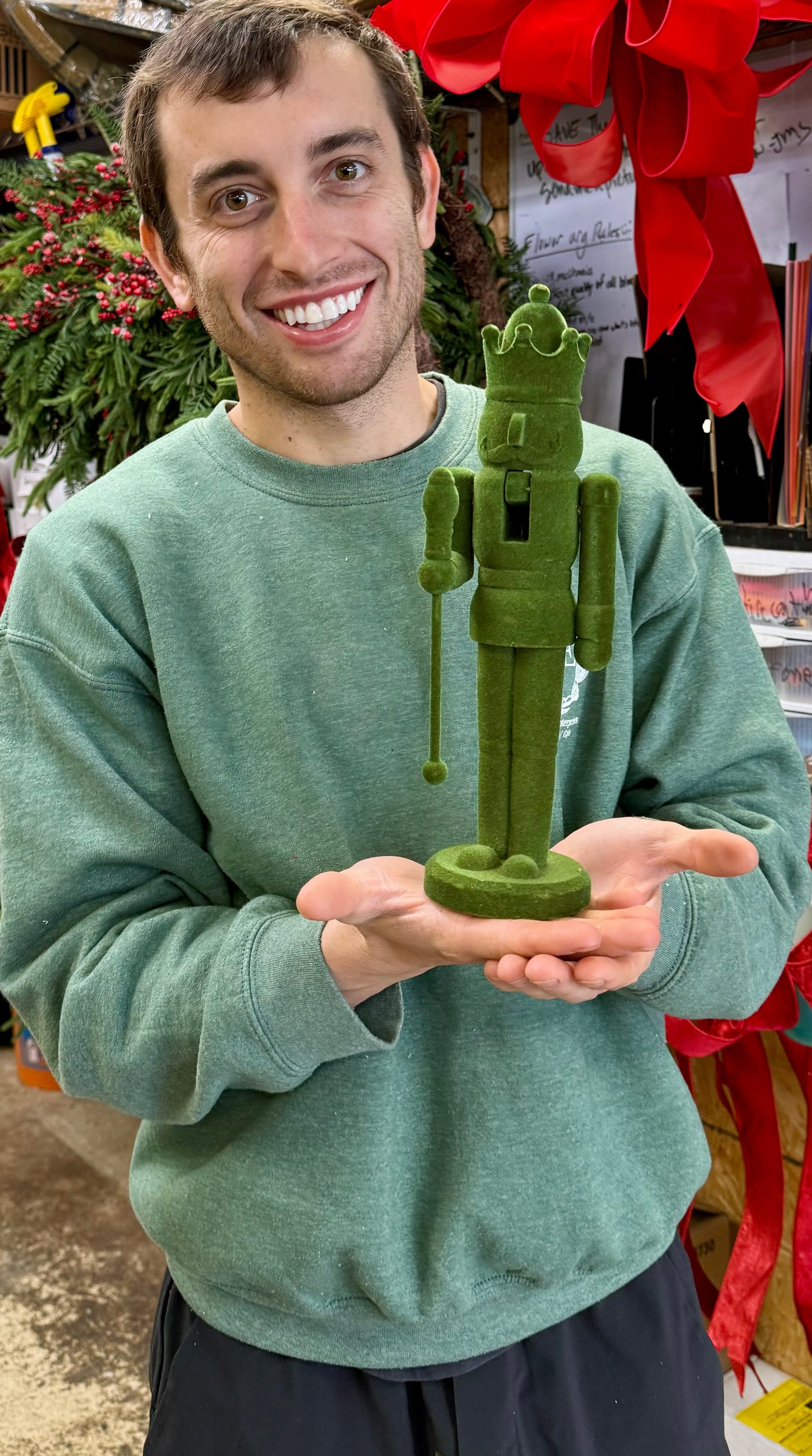 Green velvet Nutcracker holding a scepter 12 inches tall.