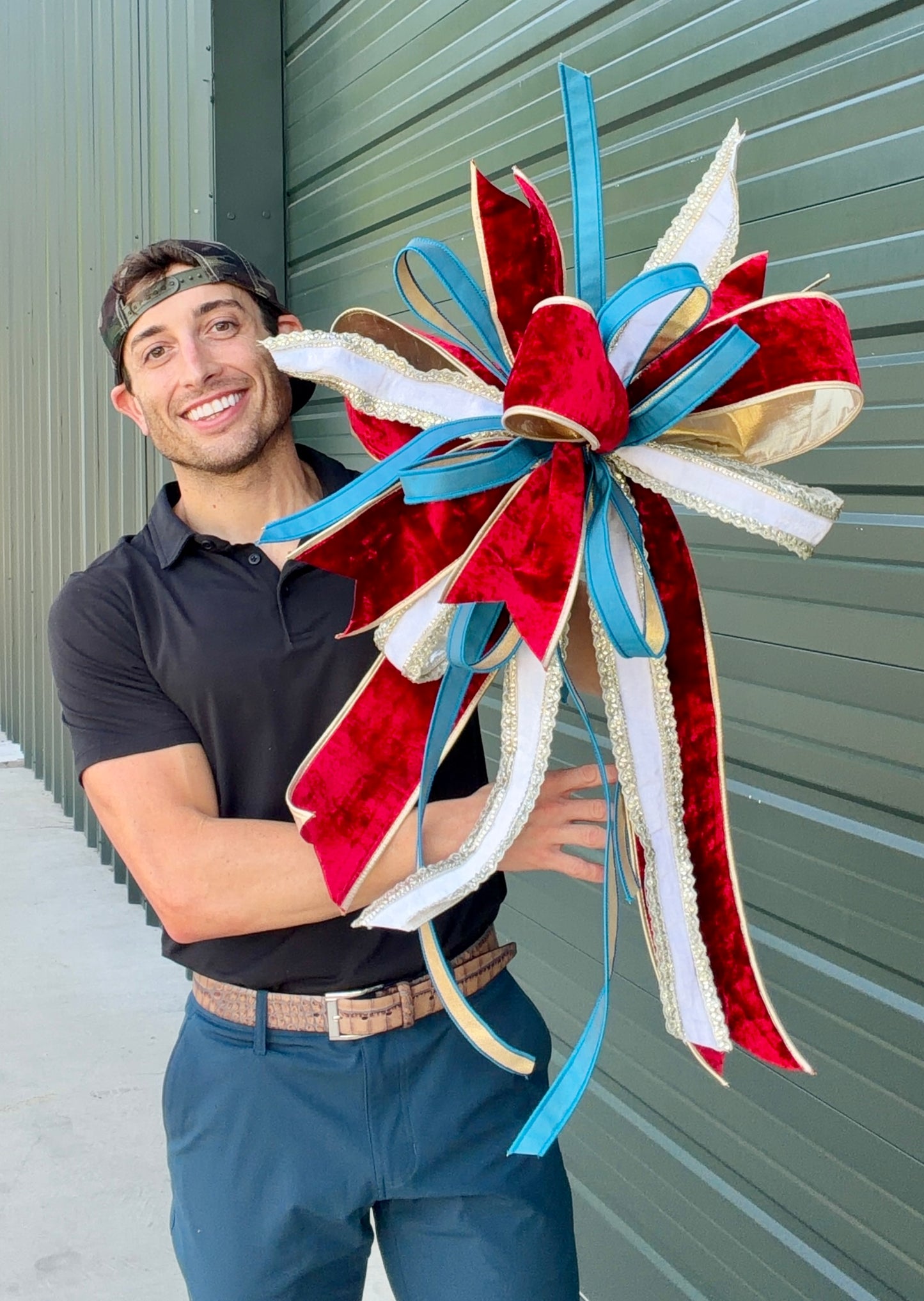 JME regal patriotic hand tied bow using JME ribbons. Some fluffing may be required upon receiving. Bow is about 23 inches wide by 30 inches long.