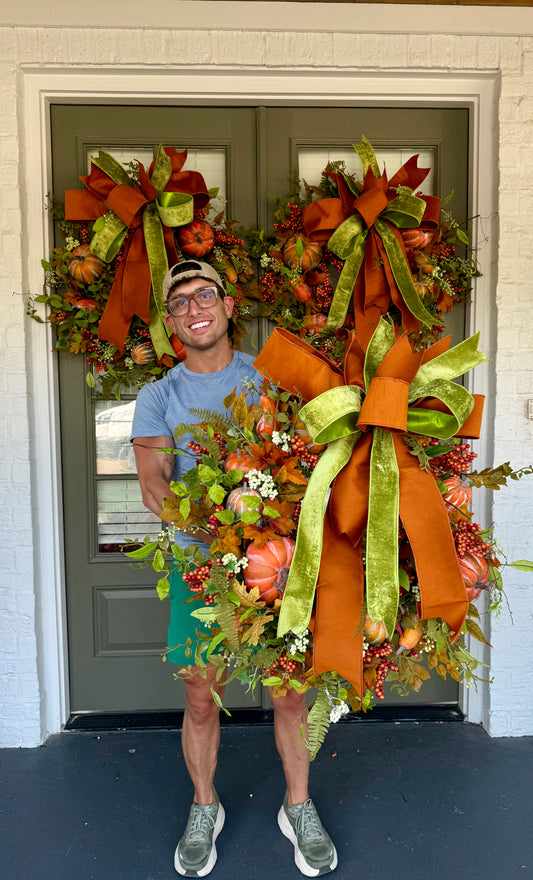 Faux pumpkin and green vine JME wreath WITH a hand tied JME bow. About 30 inches wide.
