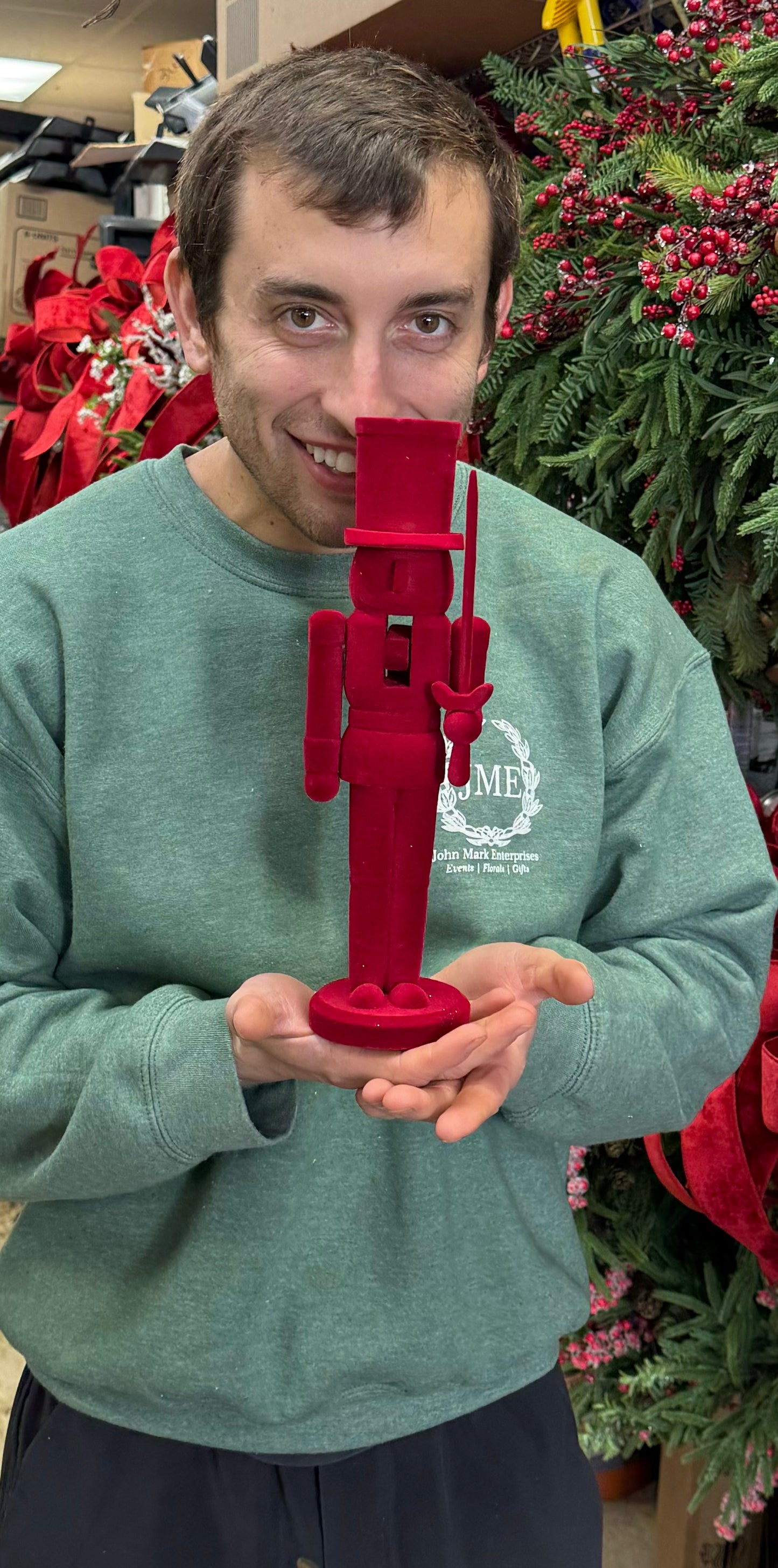 Red velvet nutcracker, holding a sword. 12in tall