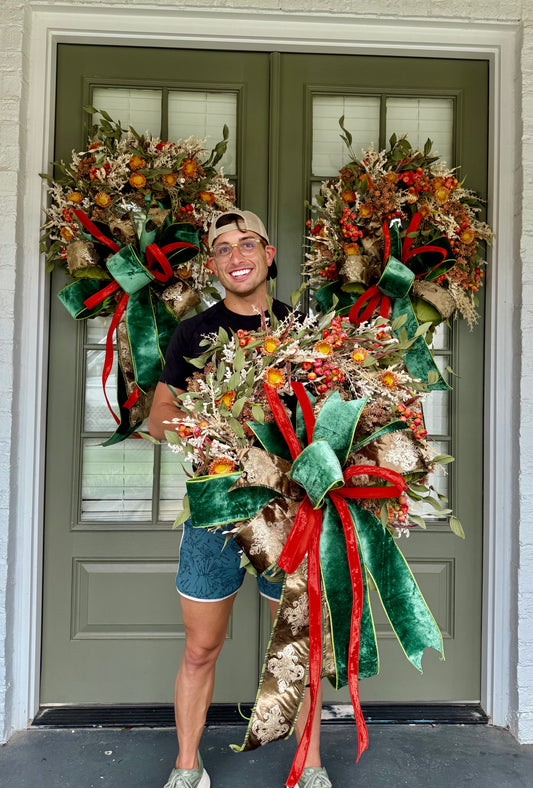 Green brown and orange faux fall wreath with hand tied JME bow. About 24 inches wide