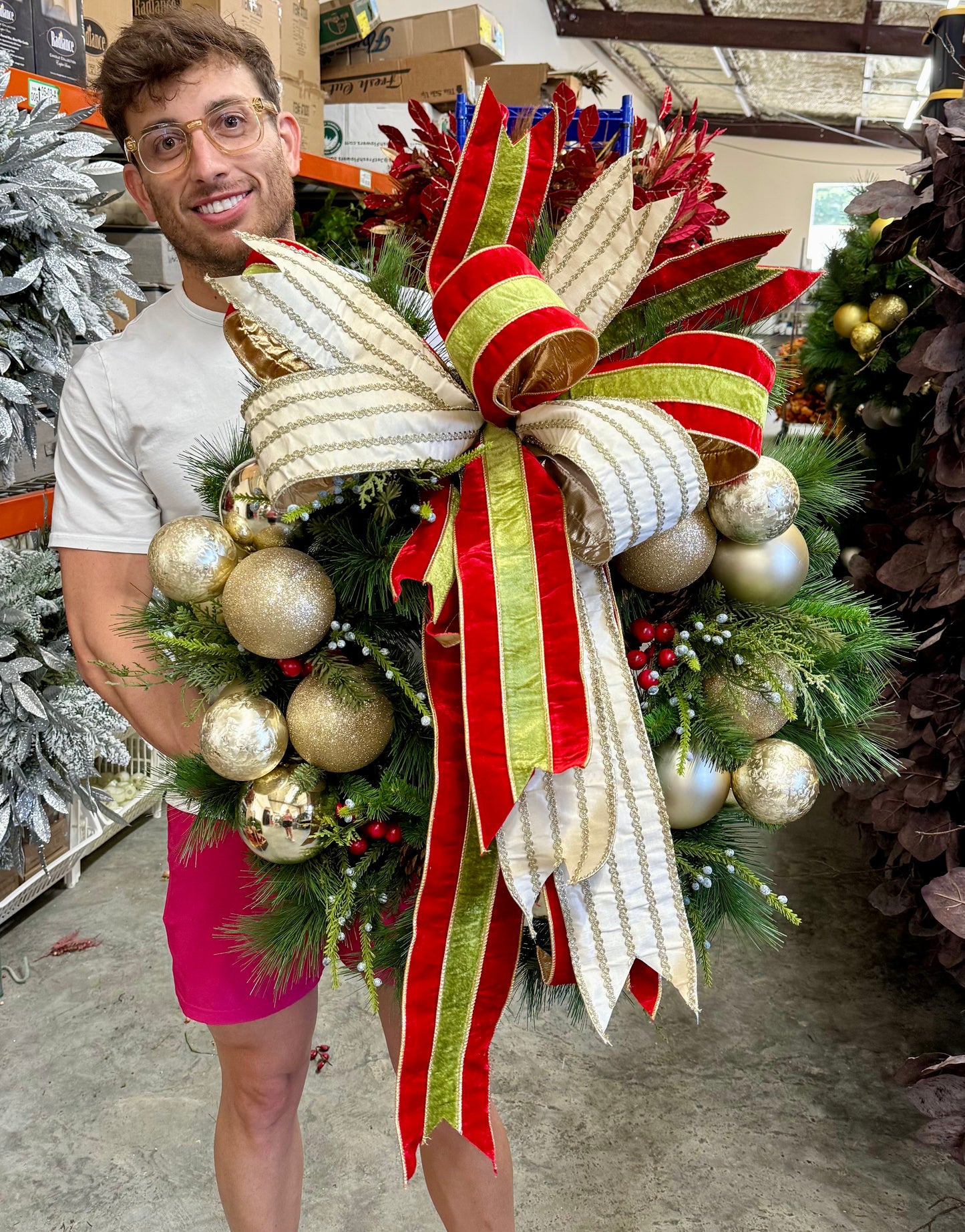 JME faux wreath with gold ornament clusters and a large JME handtied bow. 30 inches wide.