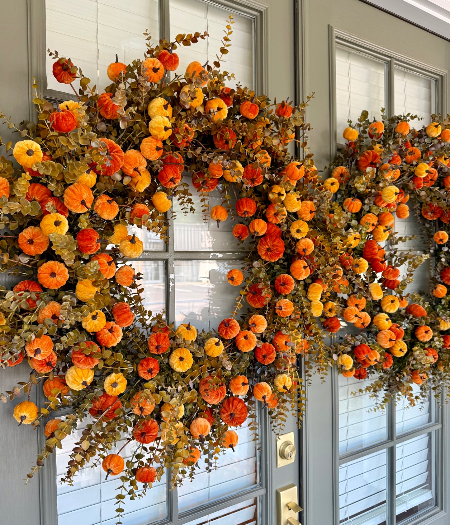 Faux orange velvet pumpkin wreath. 32 inches wide.