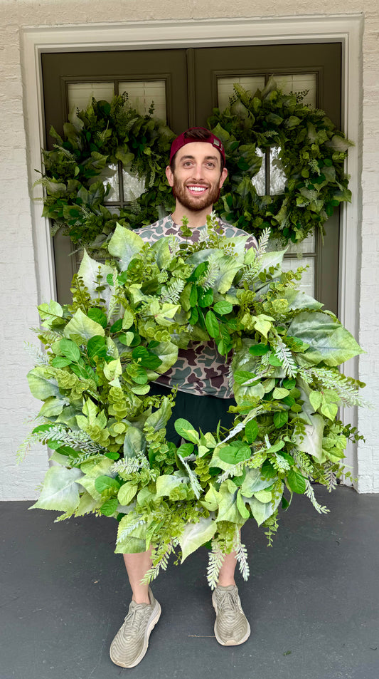 28in all faux foliage wreath. Made with different textures and shades of greenery.