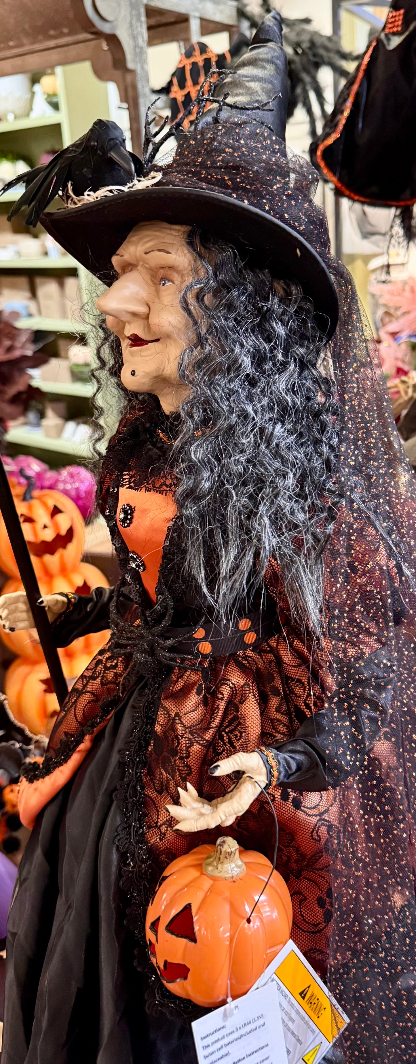 Tall witch figurine, holding a light up jack-o’-lantern. 42 inches tall. Has a Crow on her hat!